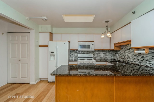 1220 Depot St Unit 411, Glenview, IL 60025 - kitchen with white appliances, a sink, a peninsula, light wood finished floors, and decorative backsplash