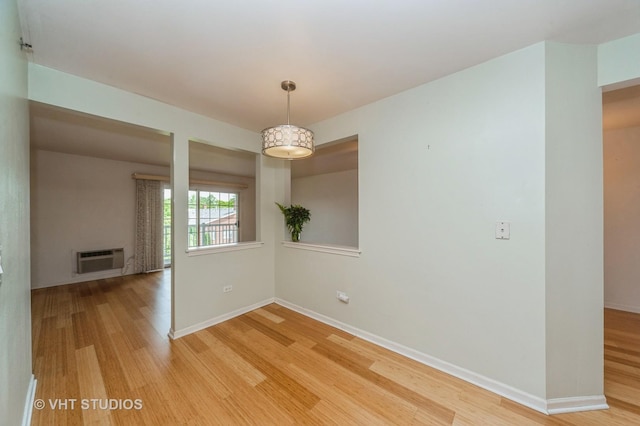 1220 Depot St Unit 411, Glenview, IL 60025 - empty room featuring light wood finished floors, baseboards, and a wall unit AC