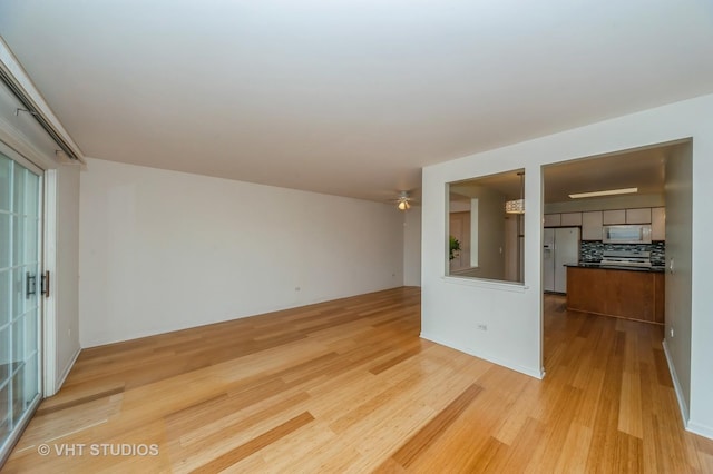1220 Depot St Unit 411, Glenview, IL 60025 - unfurnished living room featuring light wood finished floors and a ceiling fan