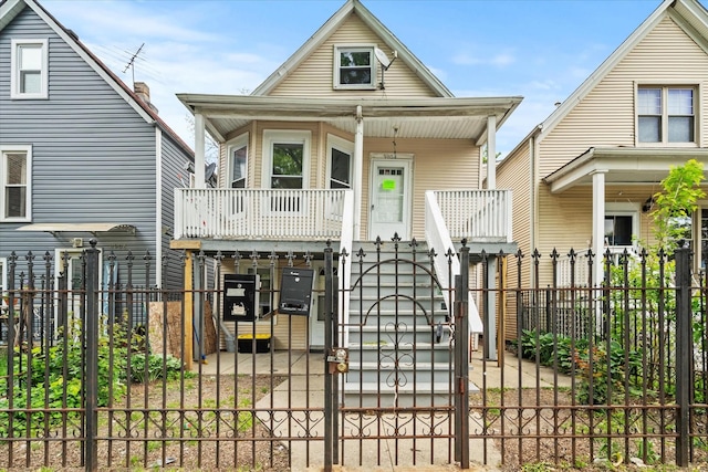 3904 W Montrose Ave, Chicago, IL 60618 - shotgun-style home with a gate, a porch, stairs, and a fenced front yard