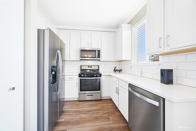 1754 Fieldstone Dr N, Shorewood, IL 60404 - kitchen with appliances with stainless steel finishes, a sink, white cabinets, backsplash, and light countertops