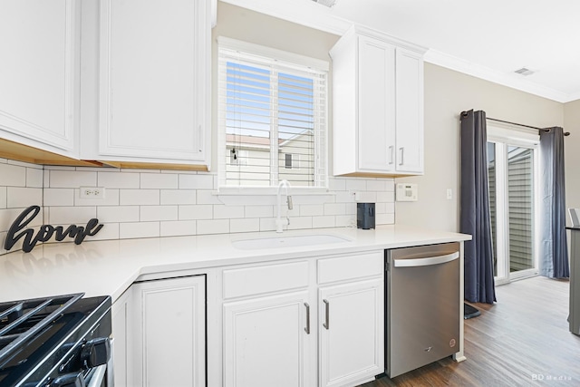 1754 Fieldstone Dr N, Shorewood, IL 60404 - kitchen featuring stainless steel dishwasher, a sink, gas stove, tasteful backsplash, and white cabinetry