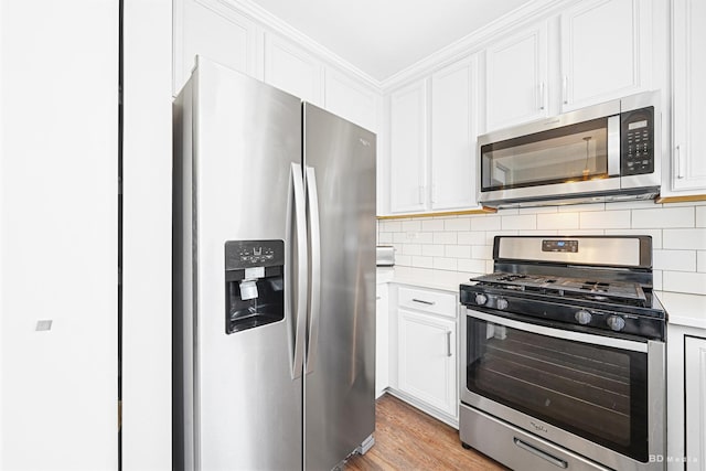 1754 Fieldstone Dr N, Shorewood, IL 60404 - kitchen featuring appliances with stainless steel finishes, light countertops, white cabinetry, and backsplash