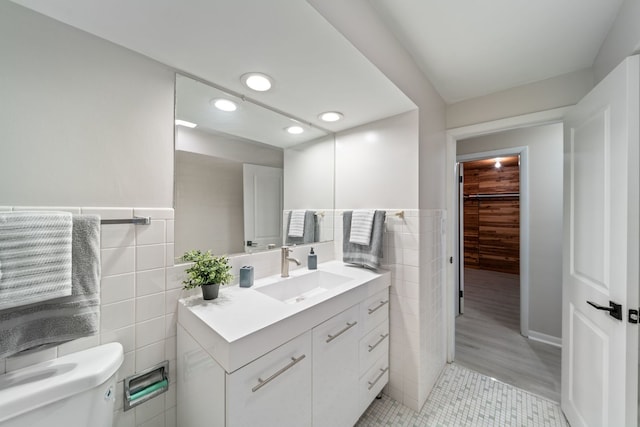 4945 N Neva Ave, Chicago, IL 60656 - bathroom featuring tile walls, vanity, toilet, recessed lighting, and tile patterned floors