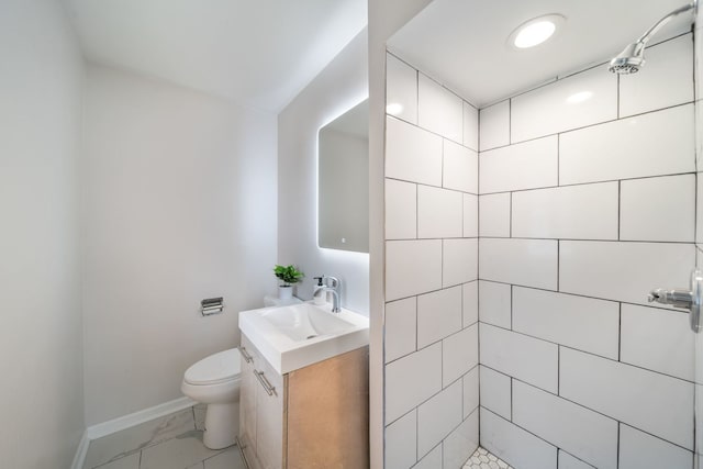 4945 N Neva Ave, Chicago, IL 60656 - bathroom with vanity, marble finish floors, a tile shower, and baseboards