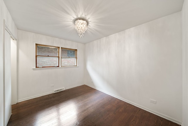4945 N Neva Ave, Chicago, IL 60656 - unfurnished room with a chandelier, dark wood-style flooring, and baseboards