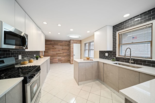 4945 N Neva Ave, Chicago, IL 60656 - kitchen with appliances with stainless steel finishes, a sink, modern cabinets, light tile patterned floors, and recessed lighting