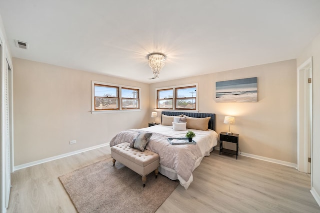 4945 N Neva Ave, Chicago, IL 60656 - bedroom with light wood finished floors, baseboards, and a chandelier
