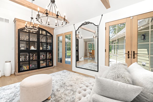 14240 W Forest Dr, Lake Forest, IL 60045 - living room with french doors, a chandelier, wood finished floors, beamed ceiling, and baseboards
