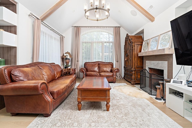 14240 W Forest Dr, Lake Forest, IL 60045 - living room with a chandelier, beam ceiling, light wood-style floors, a premium fireplace, and high vaulted ceiling