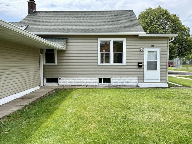 105 W 2nd St, Spring Valley, IL 61362 - rear view of property with roof with shingles, a yard, and a chimney