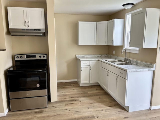 105 W 2nd St, Spring Valley, IL 61362 - kitchen featuring under cabinet range hood, stainless steel electric range oven, a sink, and white cabinetry