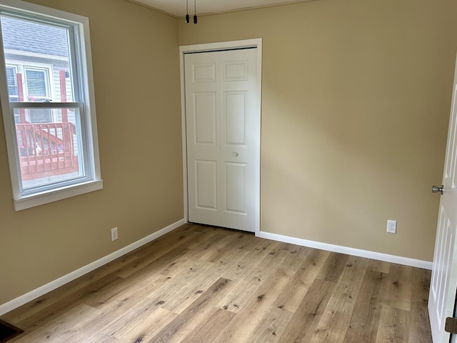 105 W 2nd St, Spring Valley, IL 61362 - unfurnished bedroom with baseboards, light wood finished floors, and a closet