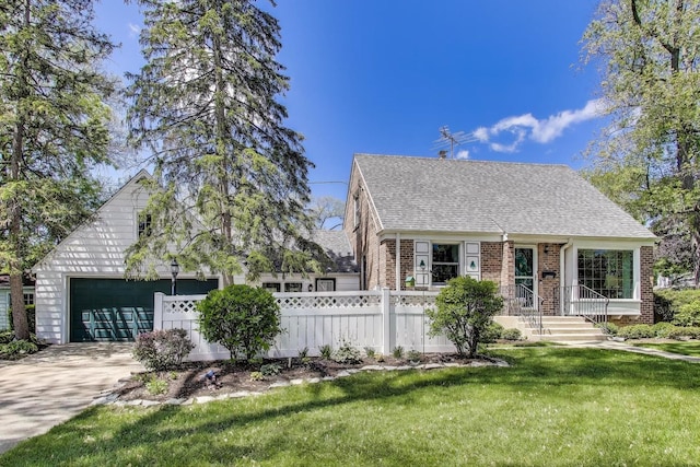 266 S Warrington Rd, Des Plaines, IL 60016 - cape cod home featuring a garage, roof with shingles, brick siding, and concrete driveway