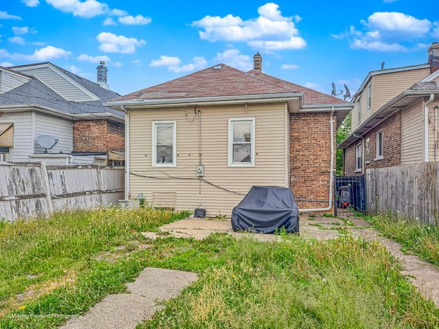 1508 N Massasoit Ave, Chicago, IL 60651 - back of house featuring a fenced backyard and a chimney