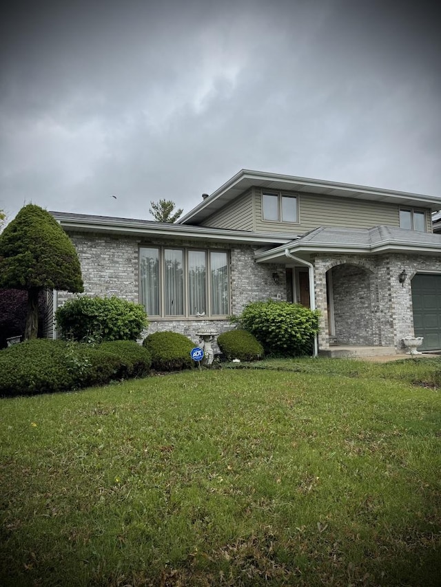 3006 Hawthorne Ln, Hazel Crest, IL 60429 - view of front facade featuring a front yard, brick siding, and a garage