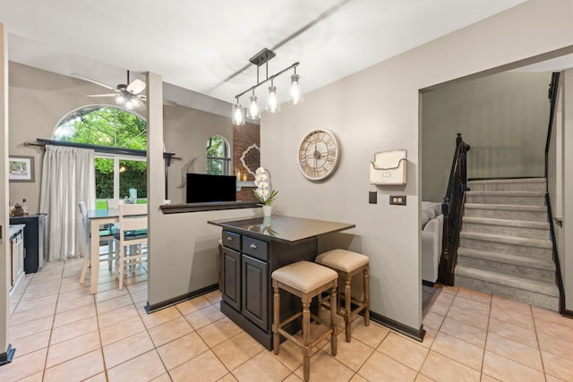1322 Coldspring Rd, Carol Stream, IL 60188 - kitchen with ceiling fan, light tile patterned flooring, dark countertops, and decorative light fixtures