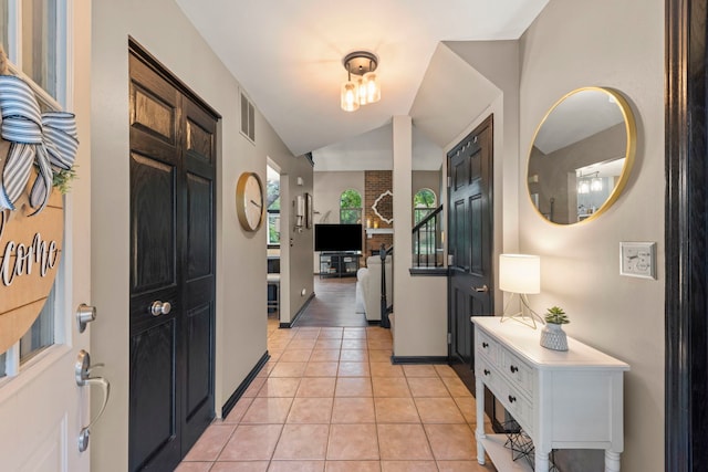 1322 Coldspring Rd, Carol Stream, IL 60188 - entrance foyer featuring light tile patterned floors, vaulted ceiling, and baseboards