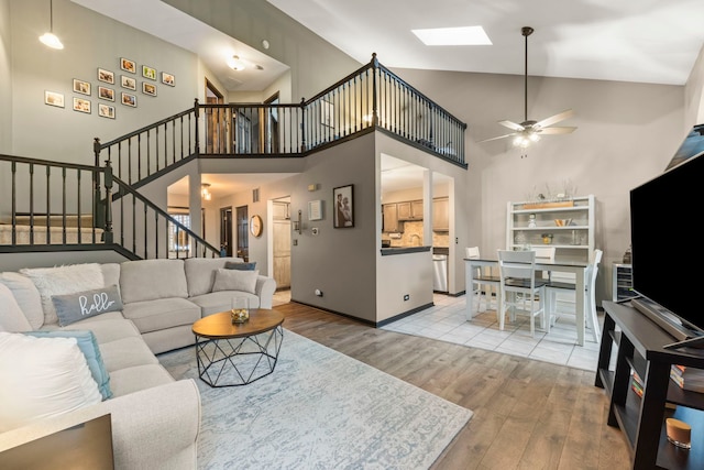 1322 Coldspring Rd, Carol Stream, IL 60188 - living room with wood finished floors, stairs, a skylight, a high ceiling, and ceiling fan
