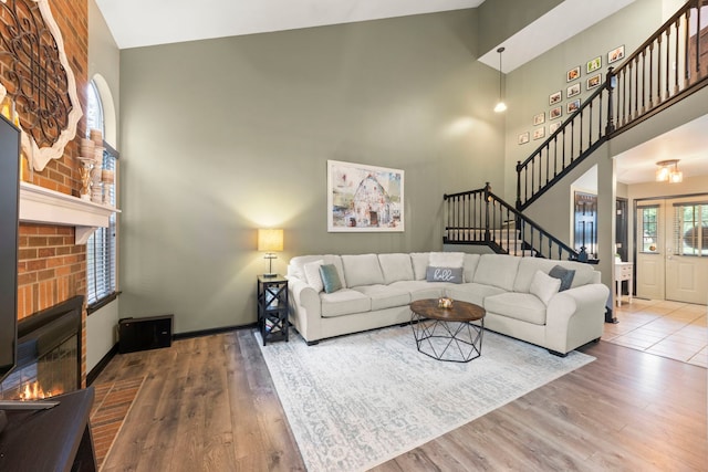 1322 Coldspring Rd, Carol Stream, IL 60188 - living room with stairs, wood finished floors, a high ceiling, a fireplace, and baseboards