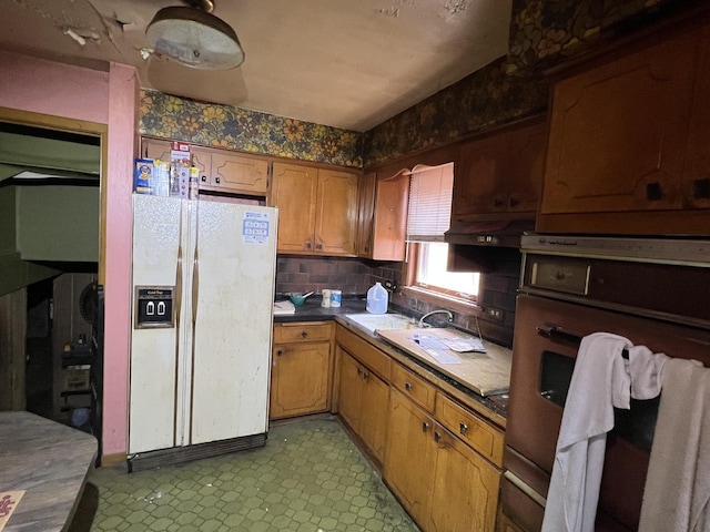 11115 S S Ave L, Chicago, IL 60617 - kitchen featuring white fridge with ice dispenser, light floors, brown cabinetry, and dark countertops