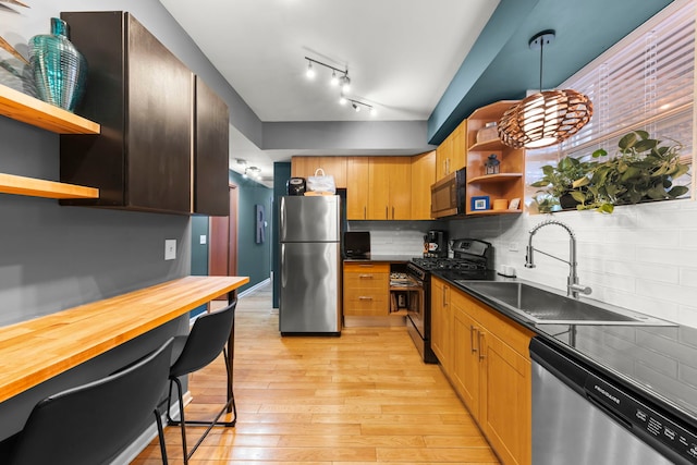5054 N Troy St Unit 3, Chicago, IL 60625 - kitchen featuring appliances with stainless steel finishes, open shelves, a sink, light wood-type flooring, and decorative backsplash