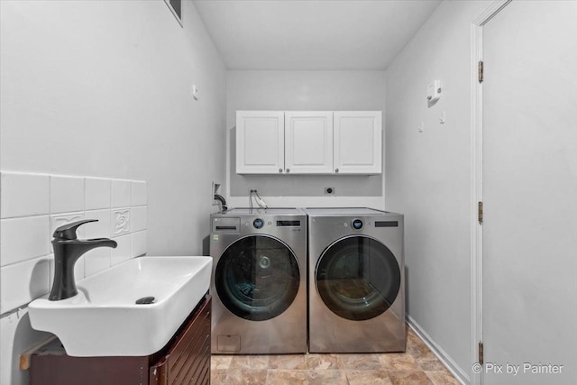 2552 Autumn Grove Ct, Aurora, IL 60504 - laundry area featuring cabinet space, independent washer and dryer, and stone finish flooring