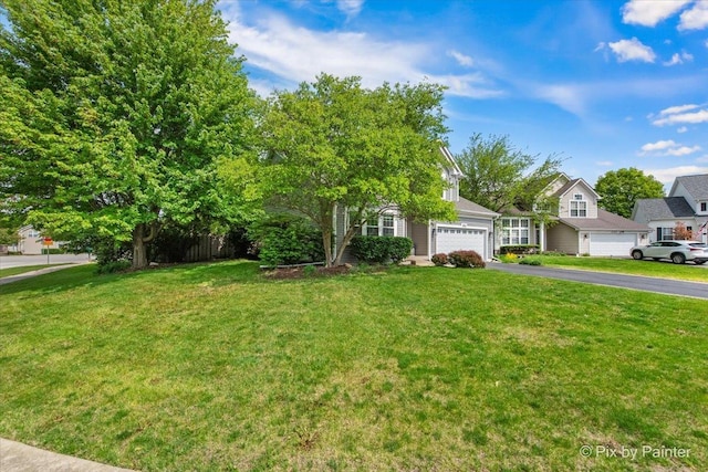 2552 Autumn Grove Ct, Aurora, IL 60504 - view of property hidden behind natural elements featuring driveway, a front yard, and a garage