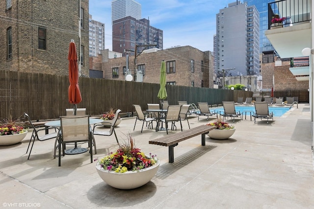 71 E Division St Unit 1606, Chicago, IL 60610 - view of patio / terrace featuring outdoor dining space, a community pool, and a city view