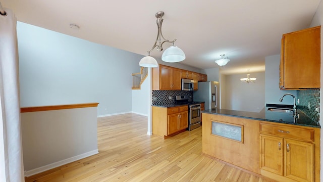16158 Hillcrest Cir, Orland Park, IL 60467 - kitchen featuring appliances with stainless steel finishes, backsplash, light wood-style flooring, brown cabinetry, and a chandelier