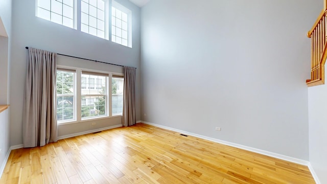 16158 Hillcrest Cir, Orland Park, IL 60467 - empty room featuring light wood-type flooring, healthy amount of natural light, and a high ceiling
