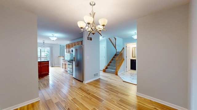 16158 Hillcrest Cir, Orland Park, IL 60467 - kitchen featuring a chandelier, stainless steel appliances, light wood-type flooring, and decorative light fixtures