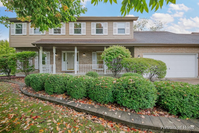 2755 Newport Dr, Naperville, IL 60565 - traditional home with brick siding, covered porch, a garage, and driveway