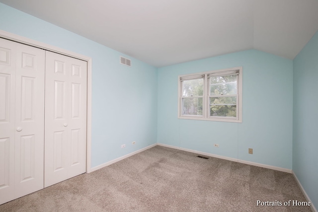 2755 Newport Dr, Naperville, IL 60565 - unfurnished bedroom with carpet flooring, lofted ceiling, and a closet
