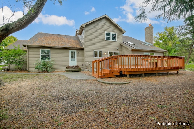 2755 Newport Dr, Naperville, IL 60565 - rear view of house with a deck, a chimney, a patio area, and roof with shingles