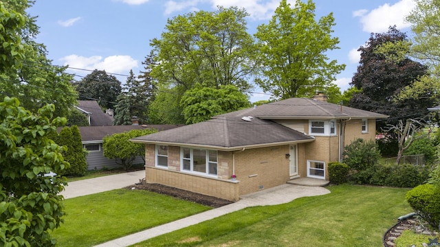 1134 N Dunton Ave, Arlington Heights, IL 60004 - back of property featuring brick siding, a chimney, a lawn, and concrete driveway