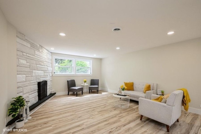 1134 N Dunton Ave, Arlington Heights, IL 60004 - living room with baseboards, light wood-type flooring, a stone fireplace, and recessed lighting