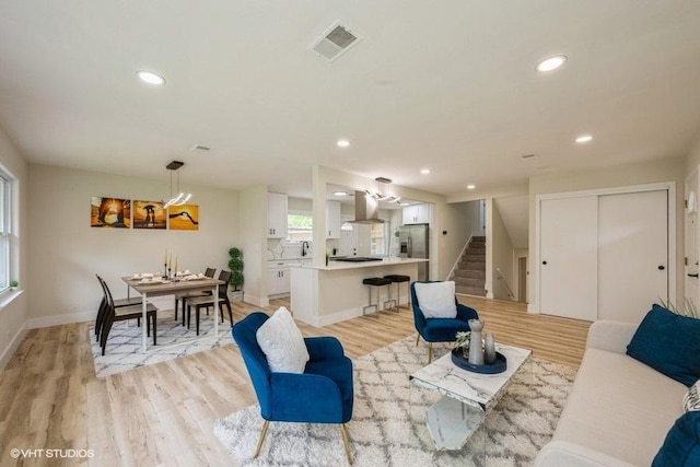 1134 N Dunton Ave, Arlington Heights, IL 60004 - living room featuring stairway, recessed lighting, light wood-style flooring, baseboards, and a chandelier