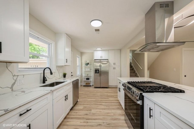1134 N Dunton Ave, Arlington Heights, IL 60004 - kitchen with stainless steel appliances, wall chimney range hood, a sink, light wood-type flooring, and white cabinets