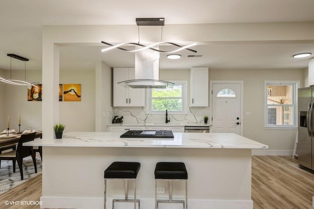 1134 N Dunton Ave, Arlington Heights, IL 60004 - kitchen with white cabinets, stainless steel appliances, light stone counters, a chandelier, and light wood-type flooring