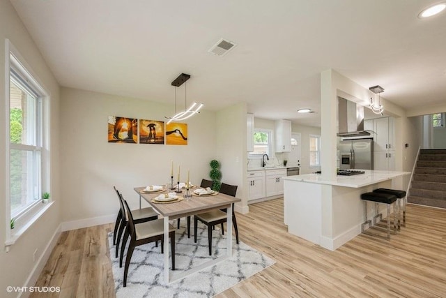 1134 N Dunton Ave, Arlington Heights, IL 60004 - dining space with light wood finished floors, stairs, baseboards, and recessed lighting