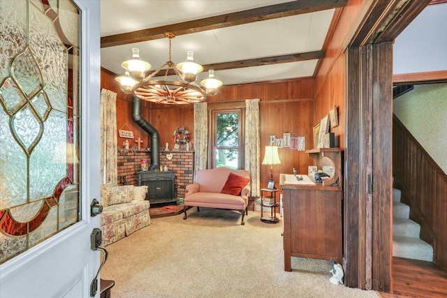 2385 County Road 1550, Saint Joseph, IL 61873 - sitting room featuring a wood stove, a chandelier, carpet floors, wood walls, and beamed ceiling
