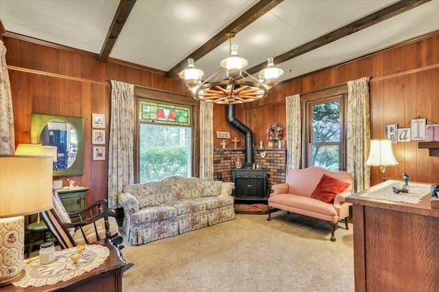 2385 County Road 1550, Saint Joseph, IL 61873 - living room featuring a wood stove, wood walls, carpet, beam ceiling, and a chandelier