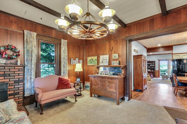 2385 County Road 1550, Saint Joseph, IL 61873 - living area with a chandelier, wood walls, beam ceiling, and wood finished floors