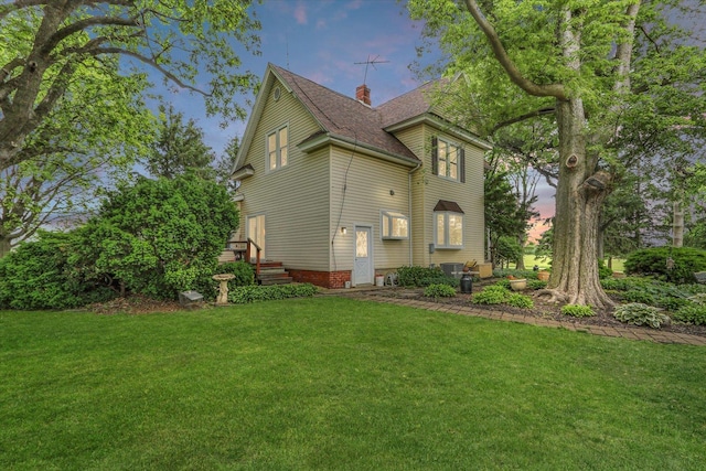 2385 County Road 1550, Saint Joseph, IL 61873 - property exterior at dusk with a lawn, a chimney, and roof with shingles