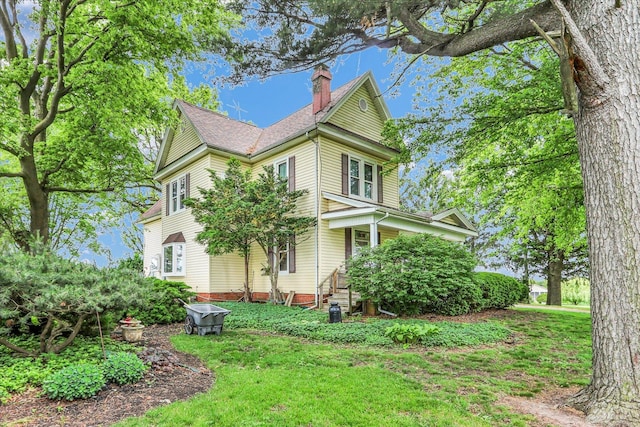 2385 County Road 1550, Saint Joseph, IL 61873 - view of front of property featuring a chimney and a front lawn