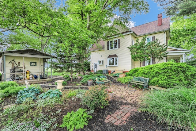 2385 County Road 1550, Saint Joseph, IL 61873 - rear view of property featuring a chimney and a patio