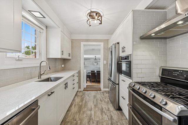 6200 N Overhill Ave, Chicago, IL 60631 - kitchen featuring stainless steel appliances, wall chimney exhaust hood, a sink, white cabinets, and decorative backsplash