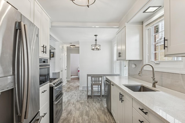 6200 N Overhill Ave, Chicago, IL 60631 - kitchen with stainless steel appliances, a sink, backsplash, and baseboards
