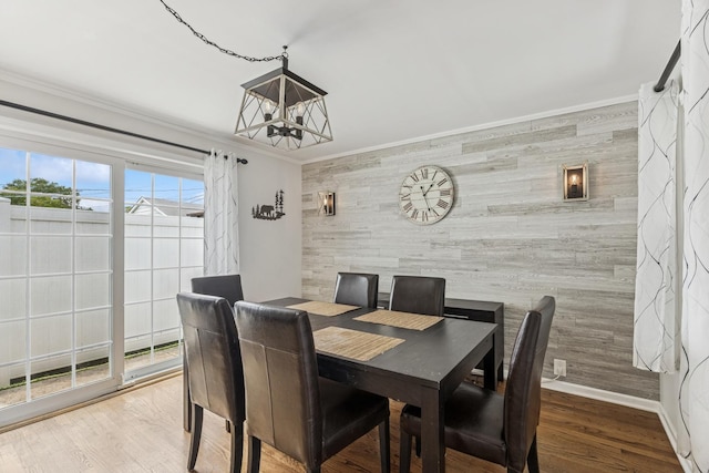 6200 N Overhill Ave, Chicago, IL 60631 - dining space with an accent wall, crown molding, a chandelier, baseboards, and wooden walls